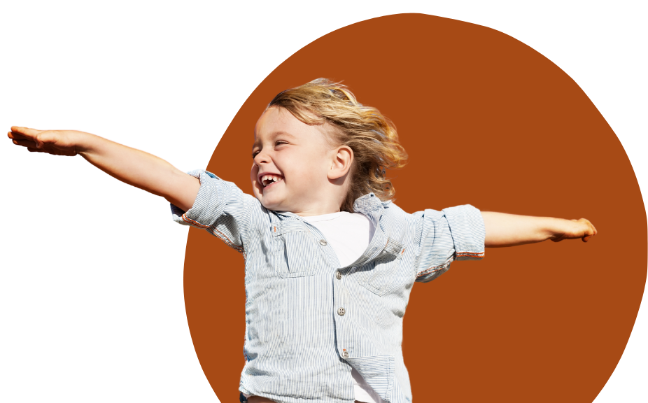 Happy child making a flying pose and smiling