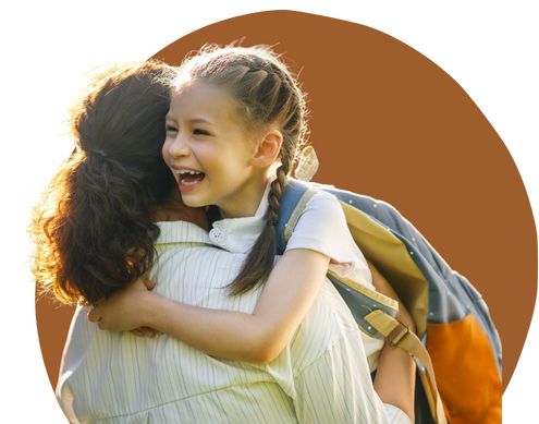 young girl happily hugging her mother after school - school support services help your child thrive in an academic setting