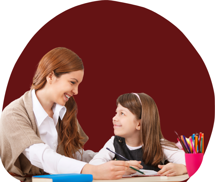 teacher smiling at student - teacher classroom consultation aba therapy