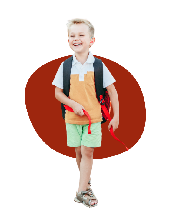 young boy with school bag happily smiling at camera - aba therapy can help your child thrive